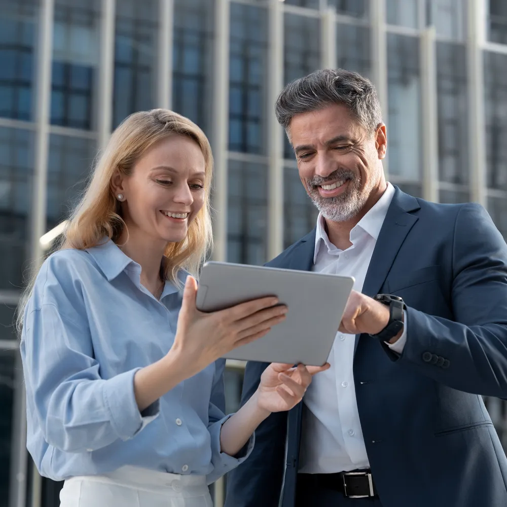 buiness woman and man looking at a tablet